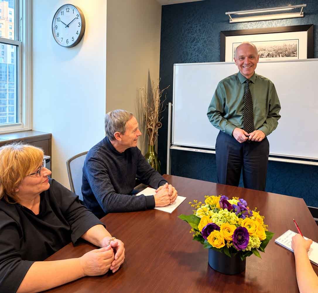 Dr. Zlatin Ivanov leading a group therapy session with adults at his New York City office