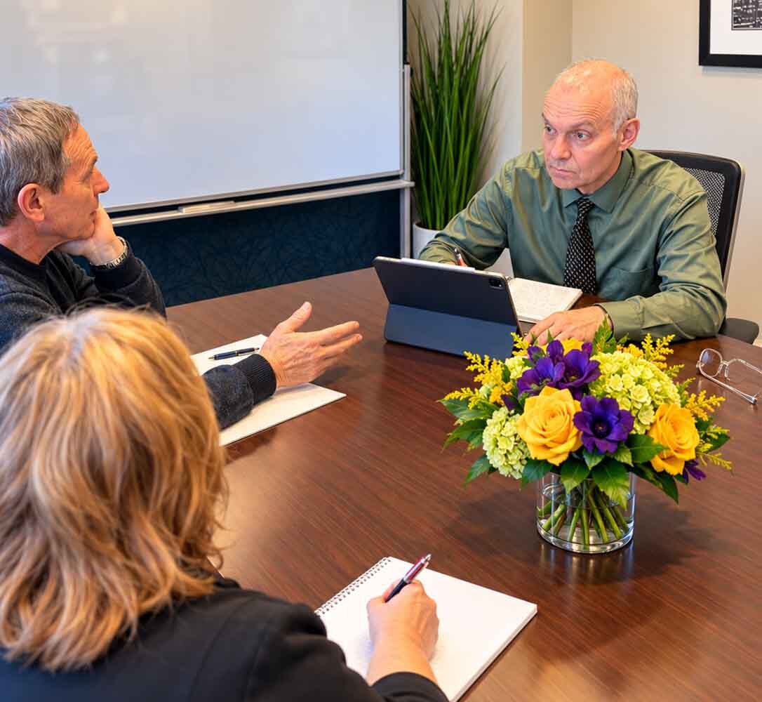 Dr. Zlatin Ivanov speaking with adults during an in-person psychiatric consultation for mood disorder treatment at his New York City office.