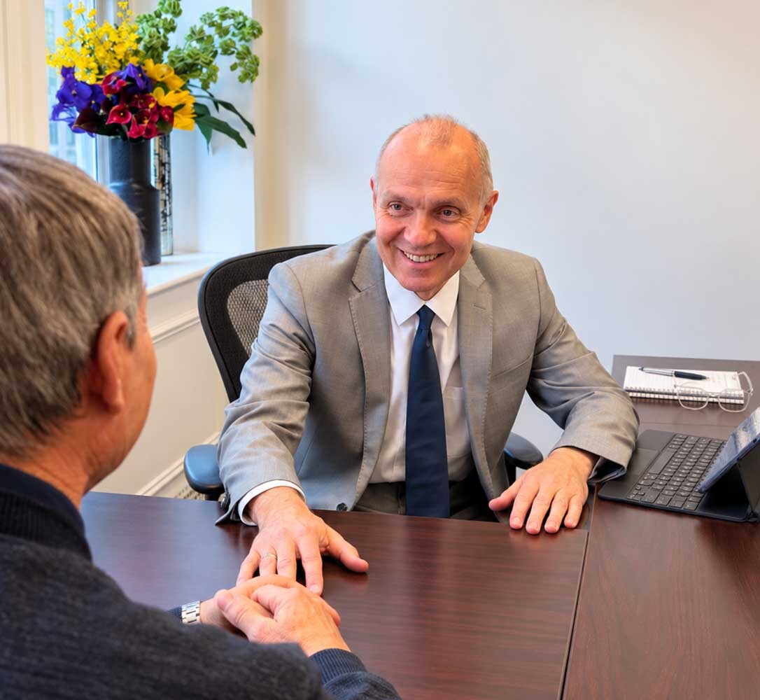 Dr. Zlatin Ivanov, board-certified psychiatrist, discussing PTSD treatment during an in-person consultation at his New York City office.